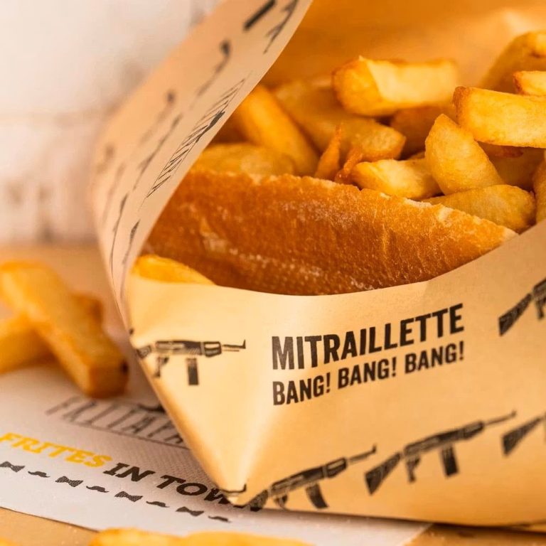 Frites croustillantes servies dans un emballage décoré de motifs militaires.